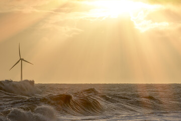 Clean energy production. Wind, wave and solar power in a beautiful seascape.
