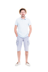 Vertical full length studio portrait of handsome bearded Caucasian man wearing summer outfit with hat standing relaxed, white background