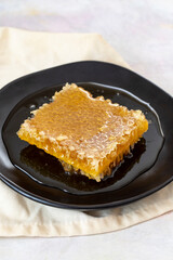 Organic honeycomb on wooden background. honey on the plate