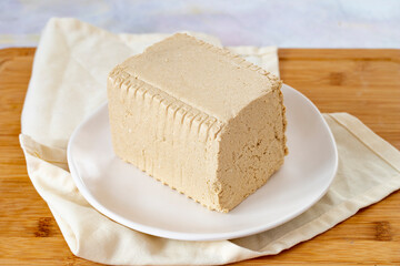 Halva with tahini on wooden background. Local name tahinli helva