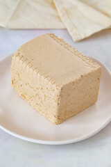 Halva with tahini on wooden background. Local name tahinli helva