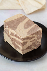 Halva with tahini and cocoa on wooden background. Local name kakaolu ve tahinli helva