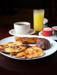 Typical Latin breakfast, ground beans, fried plantain and coffee
