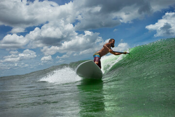 Surfer riding the SAP on high waves