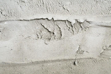 Extreme close up of a fresh, rough putty on a wall. Construction industry background texture