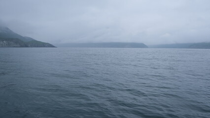 hills and mountains in big water on a gray day in the pacific ocean