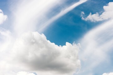 Naklejka na ściany i meble Fluffy cloud agains blue sky