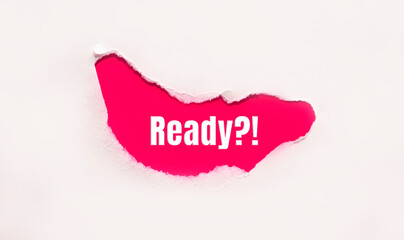 The question Are You Ready appearing behind torn brown paper.