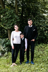 Family portrait with first grader in daylight in the park