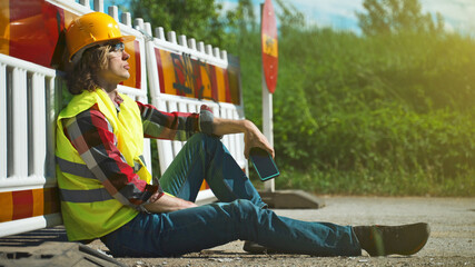 Tired male worker using smartphone on a break.