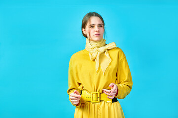 teenager girl thoughtful and reflects. emotion. blue background