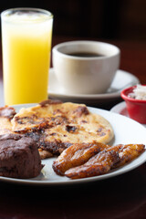 Typical Latin breakfast, ground beans, fried plantain and coffee
