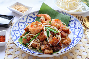 Stir fried turnip cake with shrimp, bean spout and chives - Thai -Chinese food called Kanom Pak kad or Char Koay Kak