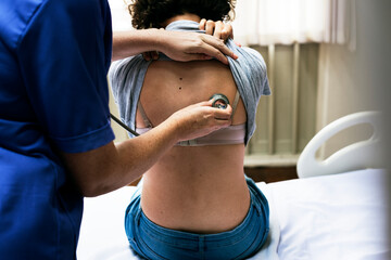 Doctor checking a breathing of a patient