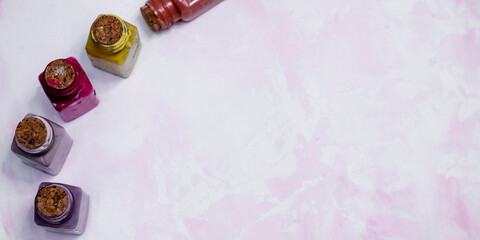 cans of paints stand on a gentle pink handmade background