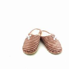 Obraz premium Women's warm home slippers. Made of pink embossed plush, decorated with bows. Isolated over white background.