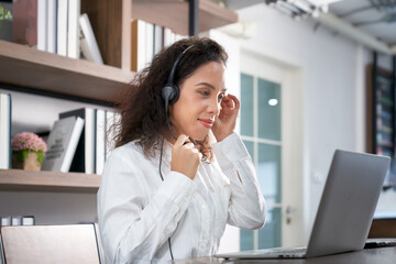 Customer support phone operator working at computer. Smiling  call center agent latin beautiful...