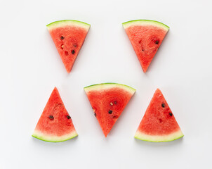 Slices of watermelon on a white background. Horizontal orientation, top view, flat lay.