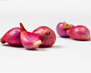 Onion isolated on white background. Consuming onions can help reduce inflammation and help boost the immune system. Shallots contain vitamin C which helps form collagen and keeps body cells healthy.