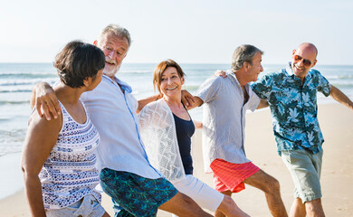 Senior friends playing at the beach