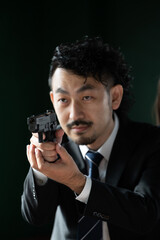 Vertical image of a cool Asian spy-style gun that could be used as a thumbnail in a case. Copy space available on the right.