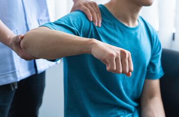 Physician consulting patients about elbow muscle pain problem ,office syndrome problems,...