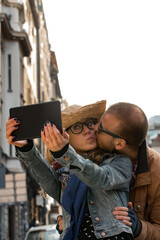 Young couple making selfie on the street in urban area.