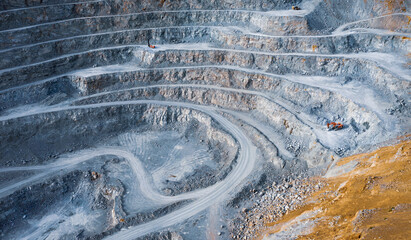 Open pit stone quarry aerial view with terraces and colorful tailings - obrazy, fototapety, plakaty
