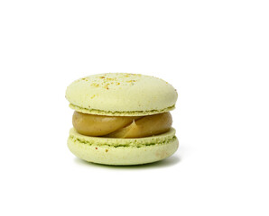 baked round pistachio macaron isolated on white background