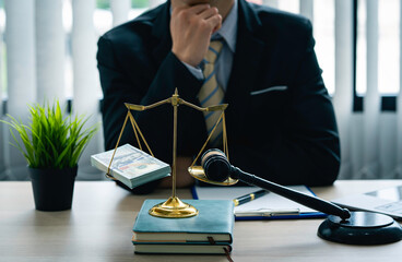 lawyer or judge Thinking about whether to accept bribes or whether to consider the case in the right way in the office of lawyers, legal counsel Scales of Justice, Law Hammer, Litigation and Justice