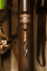 A drill inserted into a chuck on a drilling machine.