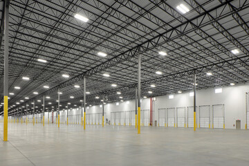 Interior of empty lit storage warehouse industrial facility building