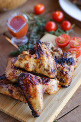 Chicken wings in marinade sweet chili grilled with cherry.