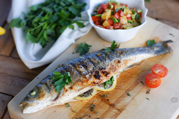 Grilled fish with avocado, orange and tomato salsa.