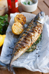 Grilled mackerel with aromatic herbs and lemon.
