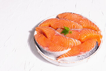 Fresh raw salmon or trout fish fillet steaks. Minimalistic design, modern hard light, dark shadow