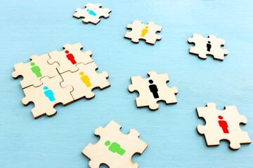 business concept image of puzzle blocks with people icons over wooden table ,human resources and management concept