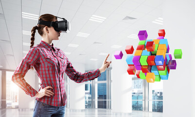 Girl in virtual reality mask experiencing virtual technology world. Mixed media