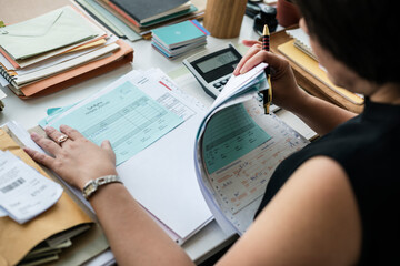 Asian woman working through paperwork