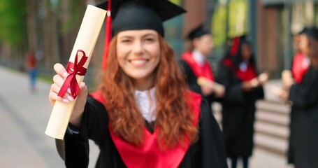 Educational concept. Happy caucasian student girl being happy at her diploma, graduation day....