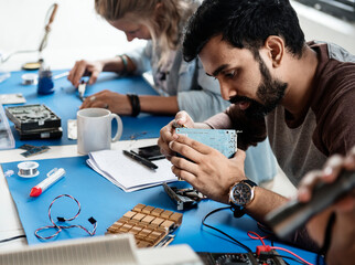 Electrical technicians working on electronics parts