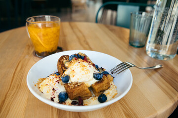 plate with ice cream and cake on the table in cafe