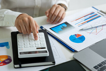 Business women working at charts, spreadsheets, graph financial development, bank accounts, statistics, economy, data analysis, investment analysis, stock exchange concept.