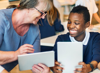 Young students using digital tablets at school