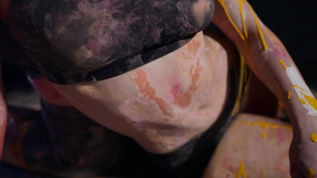 close-up of a woman body in colors on skin and clothing
