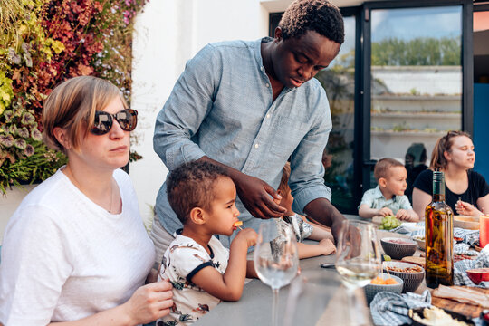 Family dinner or lunch outside on the backyard terrace