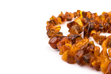 Baltic necklace made of Natural polished transparent honey luxury amber beads with inclusions on white. close up selective soft focus. Space for text