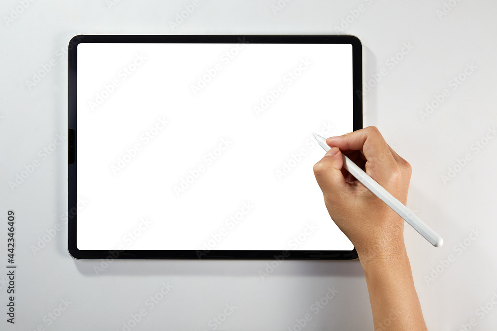 Wall mural hand writing on a mockup tablet with pencil isolated on white