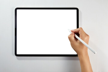 Hand writing on a mockup tablet with pencil isolated on white