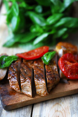 Appetizing juicy steak sliced on a wooden board.